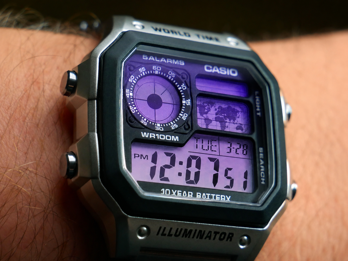 Close-up wrist view of the Purple Haze Casio AE-1200 showing the dark-to-light purple gradient display
