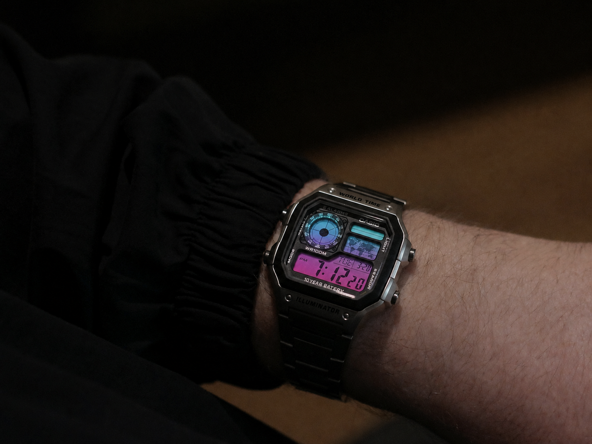 Aurora Gradient Casio AE-1200 custom watch worn on the wrist — lifestyle shot showing teal, violet and magenta gradient display