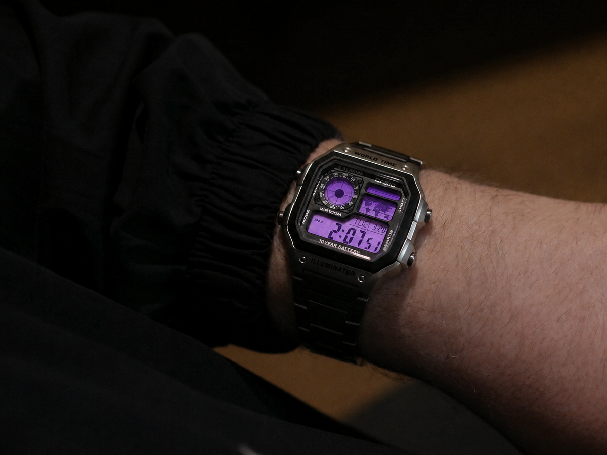 Purple Haze Casio AE-1200 custom watch worn on the wrist — lifestyle shot showing purple gradient display