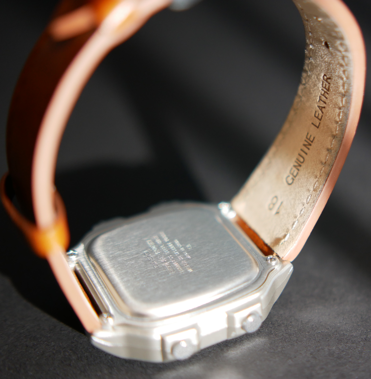 Rear view of custom Casio AE-1200 Sunset watch showing caseback and brown leather strap