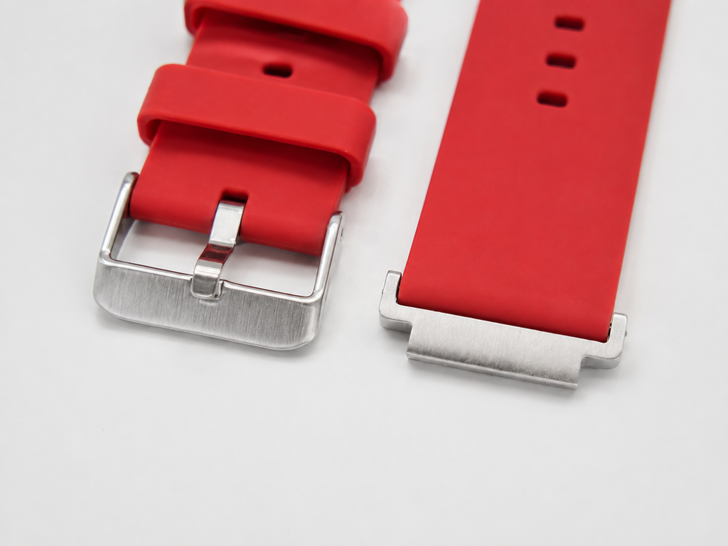 Close-up of red 22 mm watch strap with silver buckle and AE-1200 strap adaptor